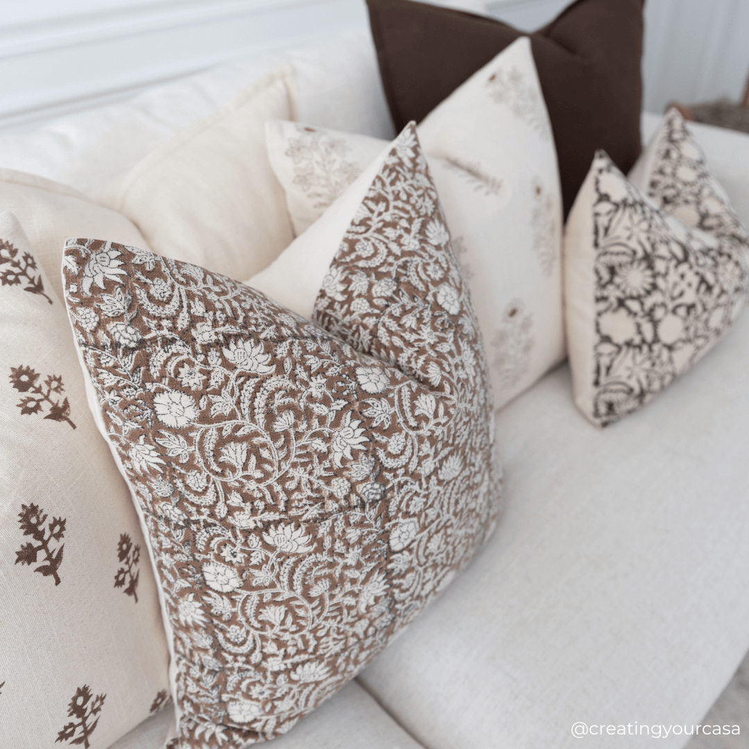 Styled shot of the Nina Floral pillow cover on a sofa